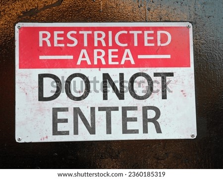 large warning text RESTRICTED AREA DO NOT ENTER on the door Royalty-Free Stock Photo #2360185319