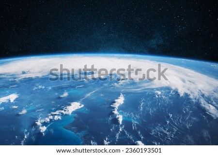 Amazing blue planet earth with ocean, clouds and continents in open space on the starry sky.