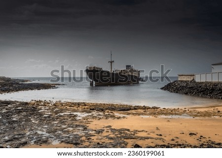The Telamon shipwreck on the sea under a cloudy sky in Lanzarote Island, Spain Royalty-Free Stock Photo #2360199061