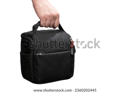 Hand holding camera bag isolated on white background