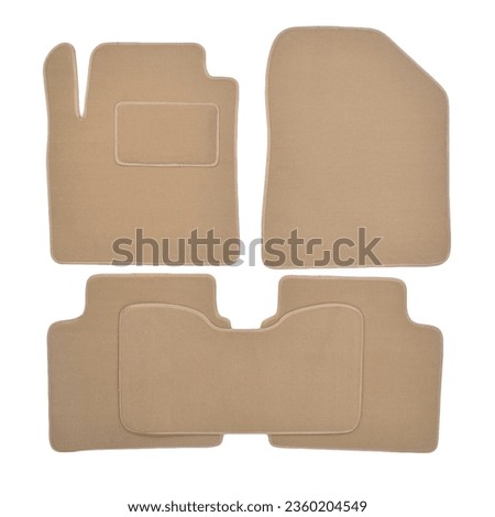 Set of textile beige car mats isolated on white background