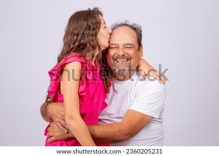 adorable little girl kisses her father's forehead