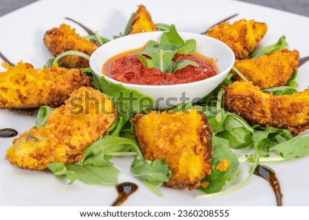 Fried avocado bite flavored with lime,
spicy tomato sauce, bed of rocket