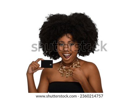 the woman smiles enthusiastically and points to a black credit card in her hand. on a white background
