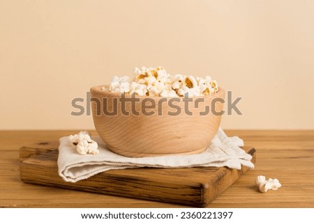 Prepared popcorn on wooden table