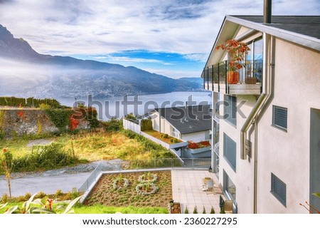 Exciting autumn view on suburb of Stansstad city and Lucerne lake with mountaines and fog. Poppular travel destination in Swiss Alps.   Location: Stansstad, Canton of Nidwalden, Switzerland, Europe