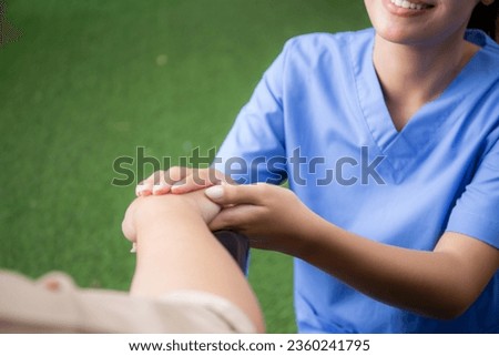 Closeup hands caregiver asian woman care elderly sitting on wheelchair, consoling for encourage in garden at hospital, senior therapy and rehabilitation with doctor for rehab, insurance and medical.