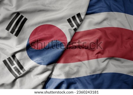 big waving national colorful flag of south korea and national flag of costa rica . macro