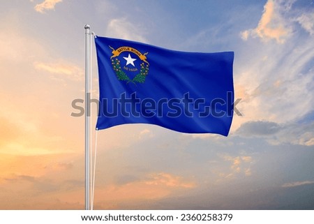 Nevada flag waving on sundown sky Royalty-Free Stock Photo #2360258379