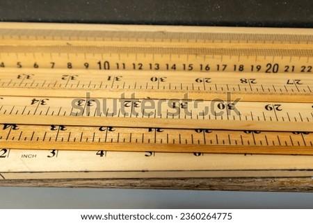 Group of wooden yard sticks and meter sticks with black background.	 Royalty-Free Stock Photo #2360264775