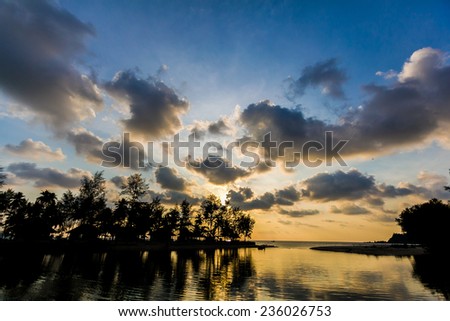 Sunset at the sea with silhouette foreground