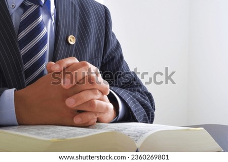 A male lawyer who reads all the six laws.

On the cover of the book, it is written as "Rokuho Zensho" in Japanese. Royalty-Free Stock Photo #2360269801