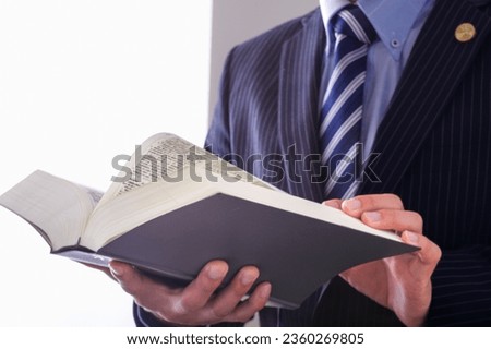 A male lawyer who reads all the six laws.

On the cover of the book, it is written as "Rokuho Zensho" in Japanese. Royalty-Free Stock Photo #2360269805
