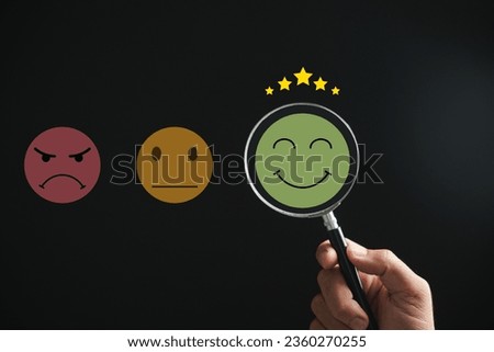 Magnifying glass discovers smiley face icon. Customer satisfaction and evaluation after service or marketing survey. Magnification, satisfaction, reputation, corporate, customer, emotion depicted.
