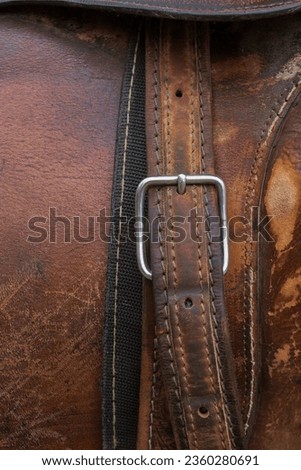 Horse saddle. Detail of the texture, stitching, buckle and leather belt.