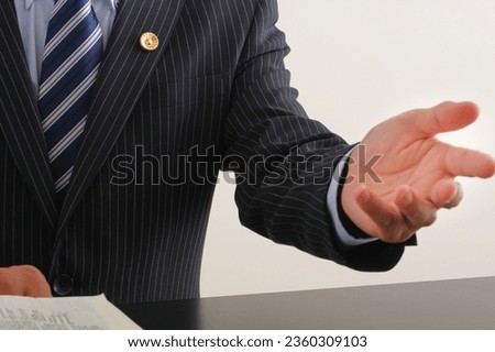 A male lawyer talking with gestures Royalty-Free Stock Photo #2360309103