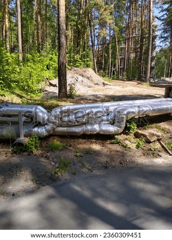 Metal pipes with communications are laid in the forest. High quality photo