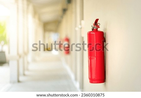 Fire extinguisher in the operating department. Fire system hanging on the wall in the hotel.
