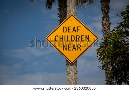 Yellow warning sign stating Deaf Children Near 