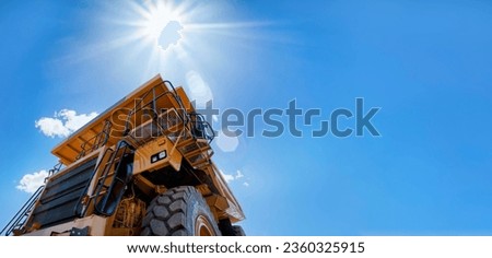 hero shot of a huge mining truck against the blue sky, design elements banner format