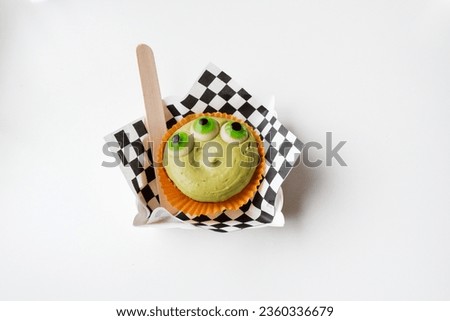 Funny Three eyes Halloween cake with jelly eyes on the table in autumn,view from above,Happy Halloween day background concept.