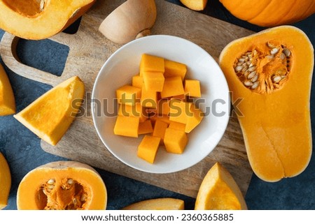 Diced butternut squash pumpkin. Sliced cubes of fresh raw pumpkins pieces. Preparing food, dicing ingredients for a seasonal autumn fall dish, soup or pie.