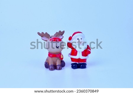 Santa Claus with reindeer doll on white background.