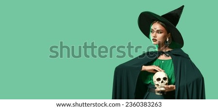 Young witch with skull on green background with space for text