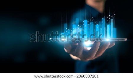 investment and finance concept, businessman holding virtual trading graph and blurred light on hand, stock market, profits and business growth. Royalty-Free Stock Photo #2360387201