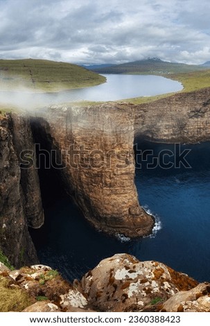 Panorama of Sorvagsvatn lake and cliffs of Traelanipa on Vagar island in sunset, Faroe Islands mountain and ocean landscape Royalty-Free Stock Photo #2360388423