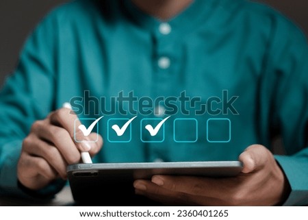 Checklist concept. Businessman using laptop. Checking mark on checkboxes.