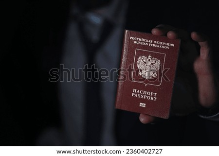 Traveling businessman handing passport black background