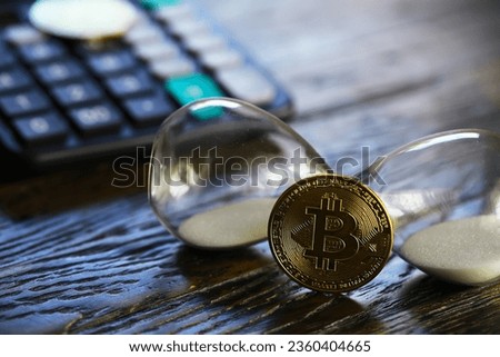 Bitcoin gold coin and defocused chart background. Virtual cryptocurrency.