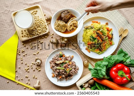 Vegetarian food, and rice scooped up by hand. Vegetarian festival is a colourfull event. Background.  Royalty-Free Stock Photo #2360405543