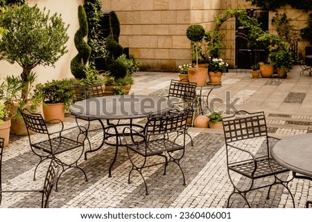 Metal tables in the garden of the restaurant