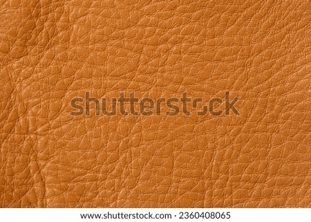 Texture of genuine leather close-up, cowhide, orange. For natural, artisan backgrounds, backdrop