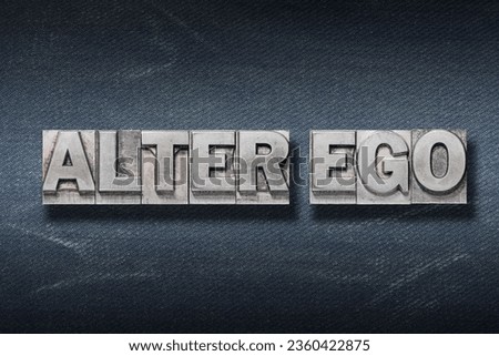 alter ego (second I) phrase made from metallic letterpress on dark jeans background Royalty-Free Stock Photo #2360422875