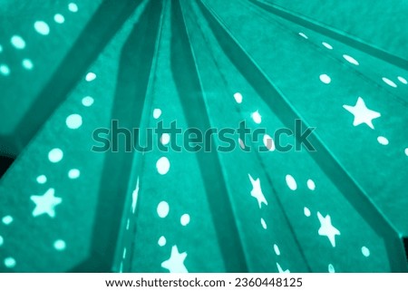 Turquoise xmas lantern star pattern at christmas market season. Shiny star mood lamp background is merry advent decoration. Traditional symbol of the best miracle time of the year. Part of series