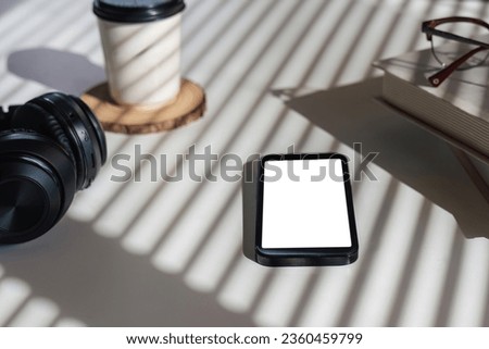 Flat lay home office desk. workspace with headphones, smartphone with empty screen mockup, coffee cup. Top view background.