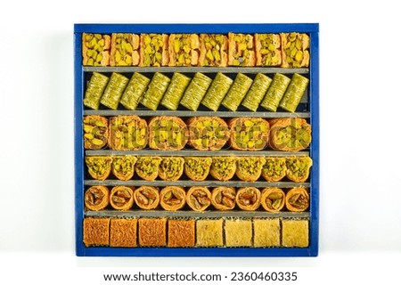 Arabic sweets boxes. Pictured from above showing several shapes and types of sweets with sesame, pistachios, dates and walnuts.