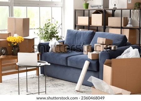 Sofa with parcels in interior of living room