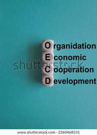 OECD - organisation economic cooperation development symbol. Concept words Organisation Economic Cooperation Development on wooden cubes. Beautiful blue background. Business concept. Copy space. Royalty-Free Stock Photo #2360468531
