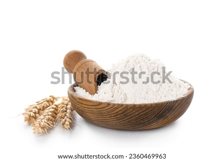 Wooden bowl with wheat flour, scoop and spikelets isolated on white background Royalty-Free Stock Photo #2360469963