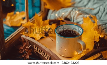 Cup Warm Coffee and Yellow Autumn Leaves by the Window. Fall Season and Home Cozy Concept. Vintage style. Royalty-Free Stock Photo #2360493203