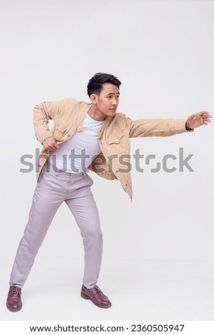 Side view of a concerned guy reaches with his hands out to offer his help. A man saving someone. Whole body photo, isolated on a white background. Royalty-Free Stock Photo #2360505947