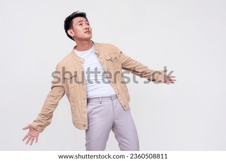 An overzealous young man looking up and surrenders himself to Gods will. Isolated on a white background. Royalty-Free Stock Photo #2360508811
