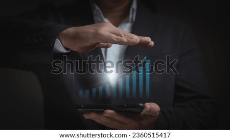 Businessman or trader showing hologram business growth, investing in trading, Planning and strategy, Stock market, Business growth, Progress success concept