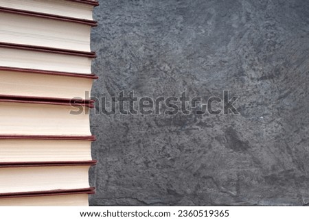 stack of books on the gray concrete background. Back to school. Education. Copy space for text