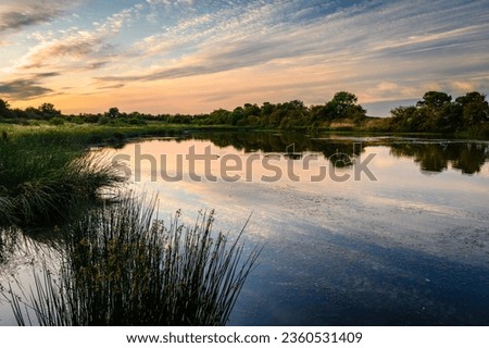 Sunset at Embleton Quarry  Nature Reserve Pond, a former whinstone quarry the new reserve is a tribute to the local community in the coastal village of Embleton who developed the site