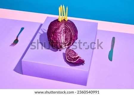 Creative image of cabbage with candles symbolizing birthday cake. Purple background. Making wishes. Concept of food, creativity, party, celebration, health. Pop art photography. Copy space for ad